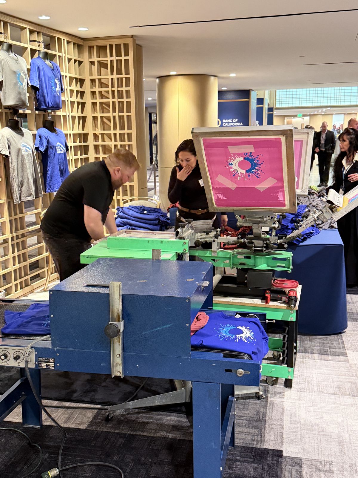 Merch Troop live printing — fresh prints off the platen